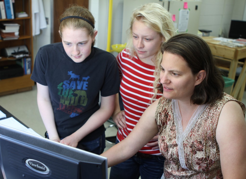 Junior Amy Christiansen '15, sophomore Alexa Peterson '16 and professor Amanda Nienow analyze data in one of the College's chemistry labs (Photo by Matt Thomas '00).