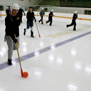 Lucas Neher '10 advances the ball during a recent intramural broomball game. (Lindsay Lelivelt '11)