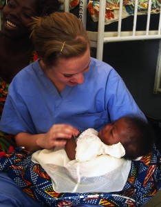 Yost comforts Gloria, a 4-month old baby girl of Aggie and Pastor Jonah, who became good friends with the students. Gloria was in the hospital during much of the group's time in Saboba, Ghana.