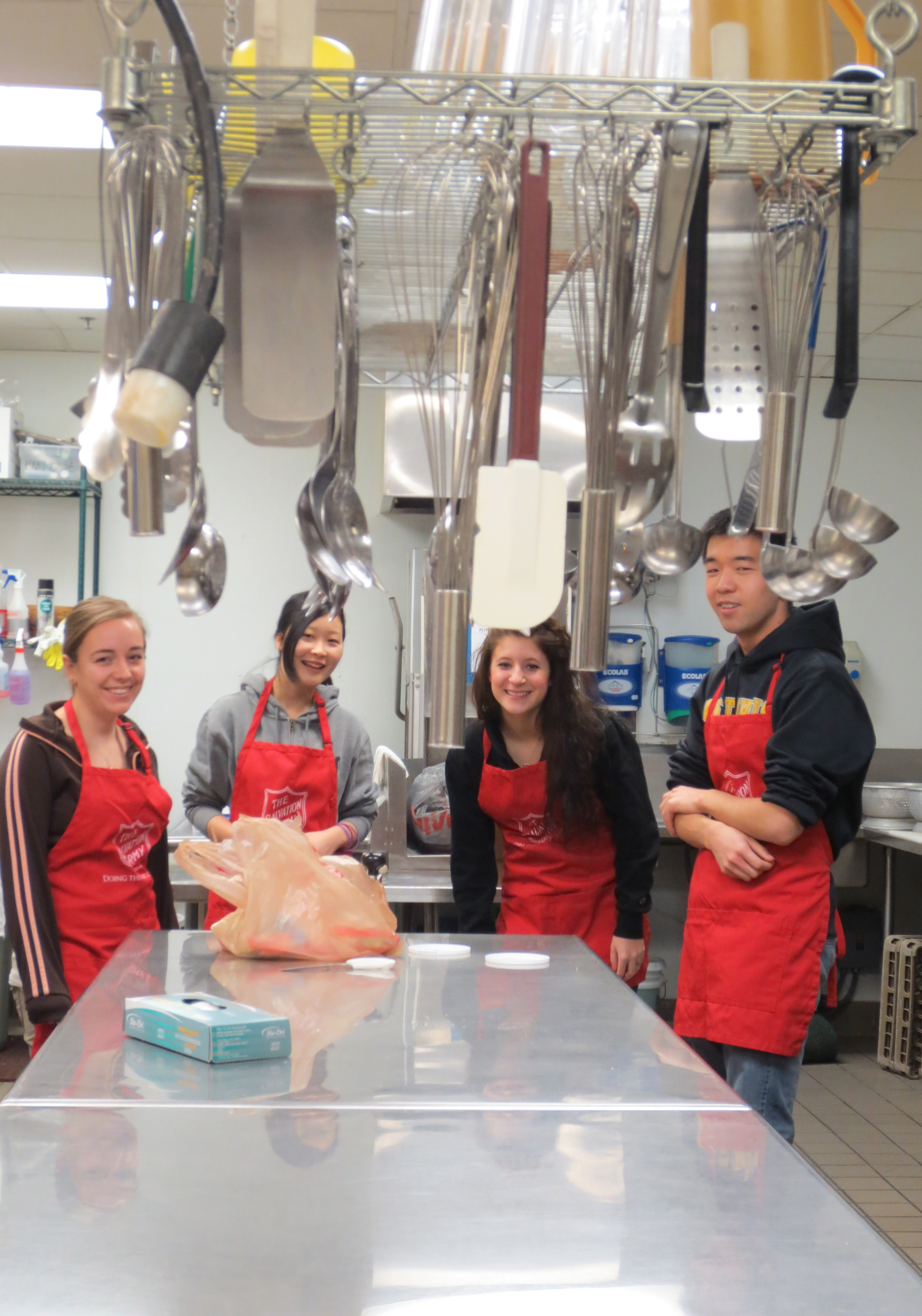 Members of Thia Cooper's January Term class volunteering at the Salvation Army men's homeless shelter in Mankato. From left to right: Sarah Spande '15, Mari Tabata '16, Taylor Robertson '16, and Kyle Bright '15.