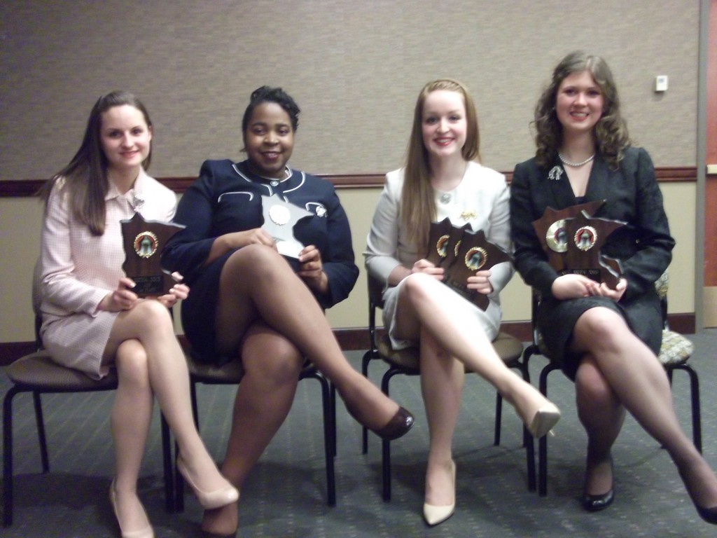 Courtney Train, Mariecus Jarvis, Shelby Wilds and Kelsey Abele with their individual championship trophies. 