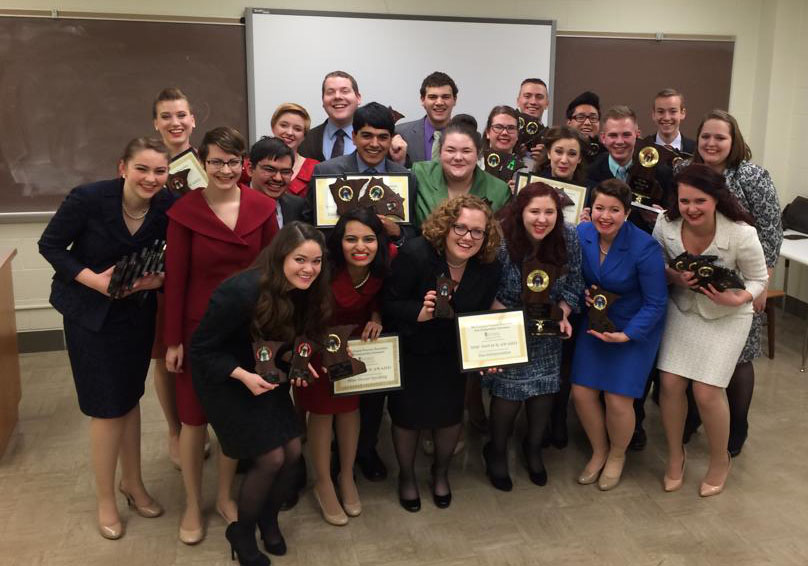 Members of the Gustavus forensics team pose with their hardware after the MCFA State Tournament on Feb. 22. 