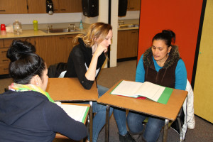Wenstrom, middle, helps community members with the English coursework.