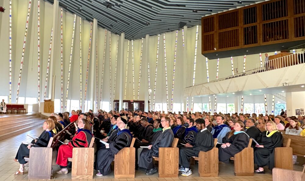 Gustavus professors in regalia in Christ Chapel for Opening Convocation for the 2023-2024 academic year.